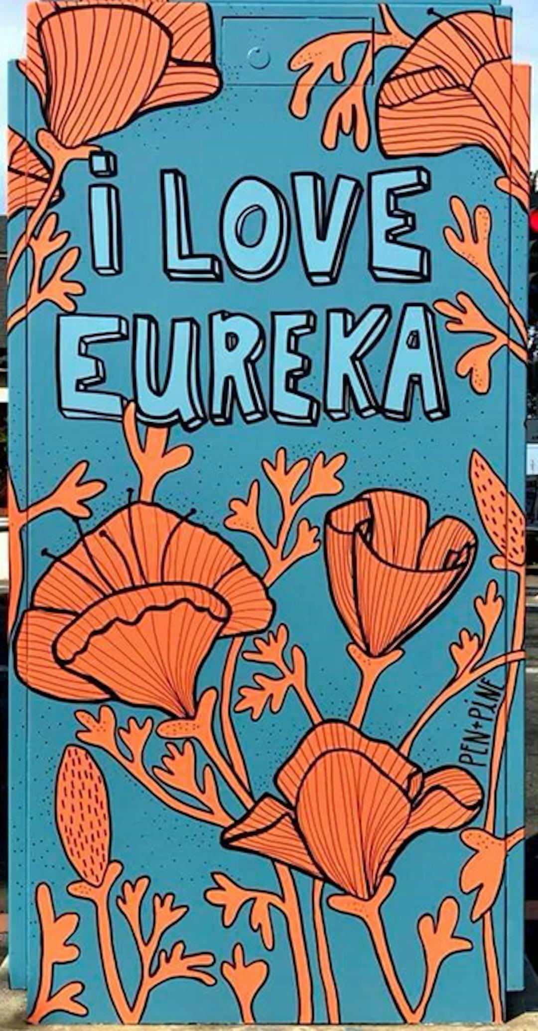 Mural on a utility box with stylized California poppies on a blue background. The mural includes the phrase "I Love Eureka"