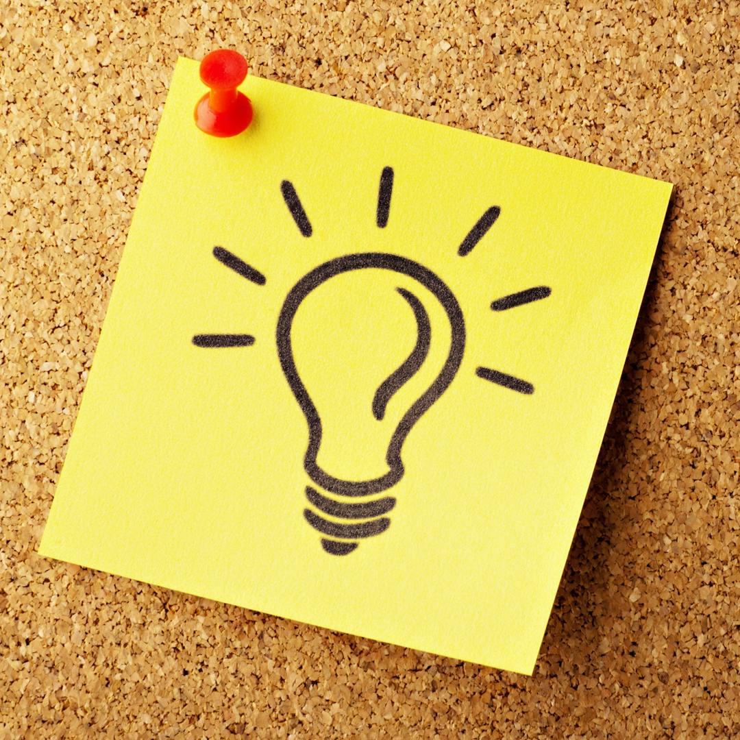 Square yellow sticky note with drawing of a light bulb