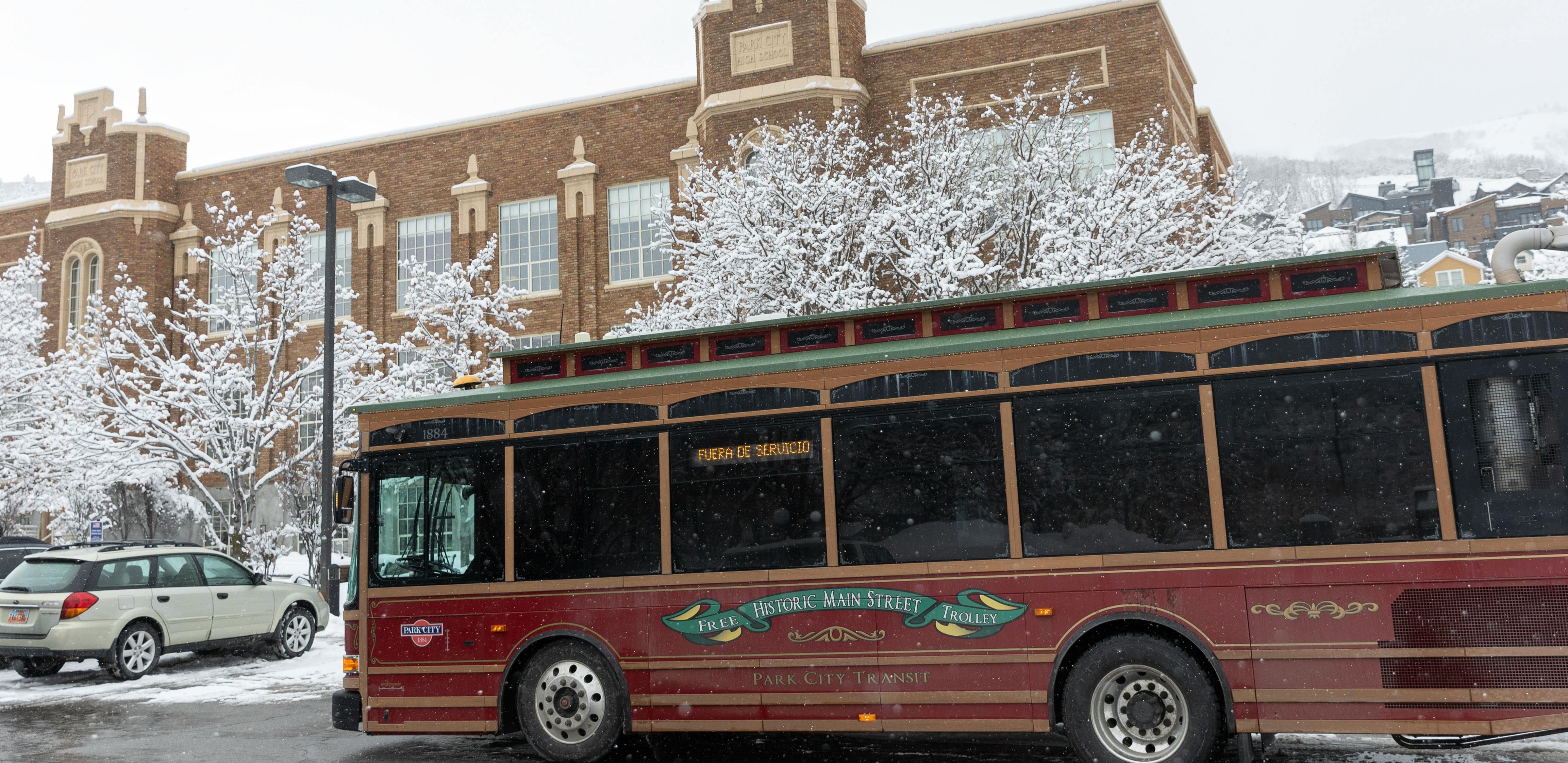 Image depicts a Park City Transit bus driving on state road 224 in the springtime.