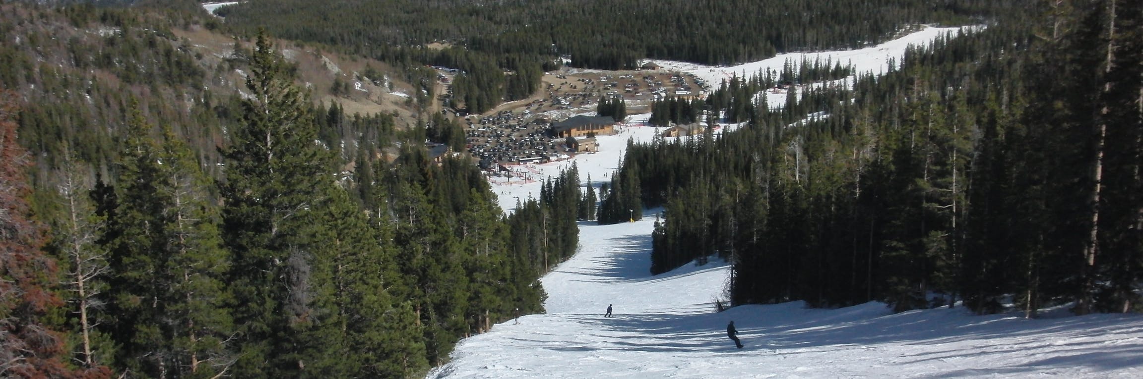 A view of the base of Eldora Ski Resort, looking down from the top of one of its slopes.