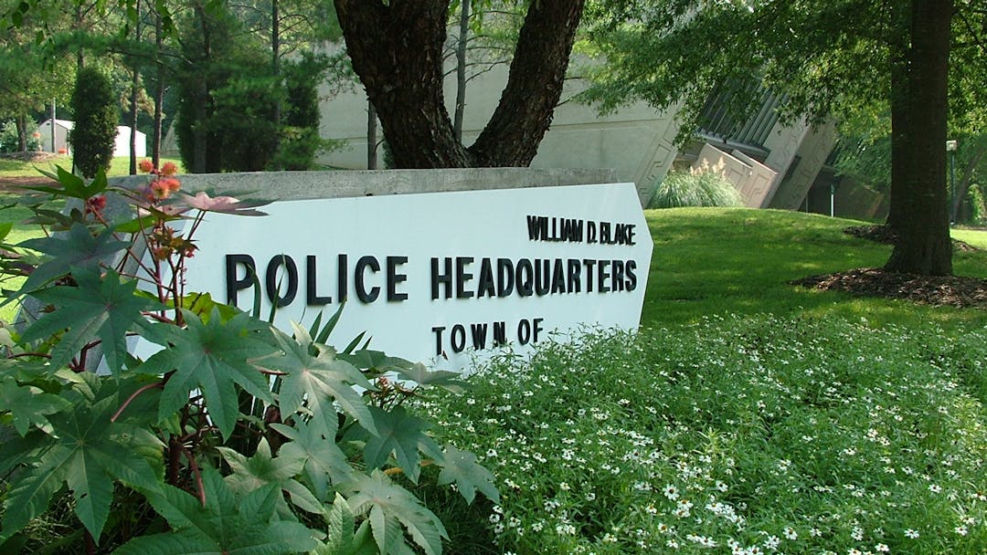 Photo of Police Headquarters sign in front of building