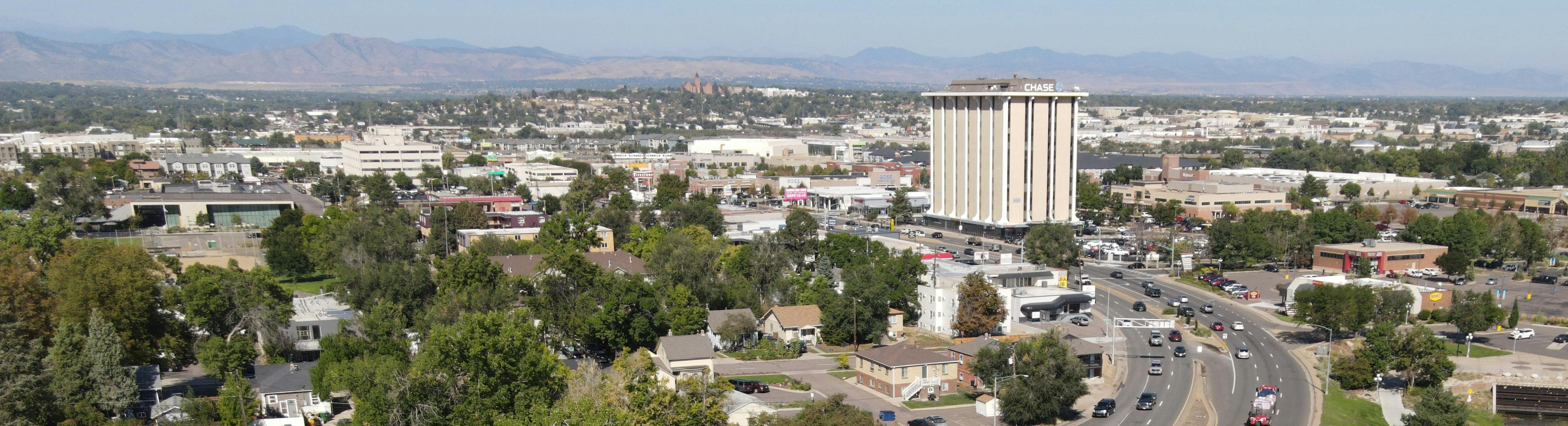 Aerial photo of Englewood, overlooking US 285 facing west with the Chase building and the mountains in the background.