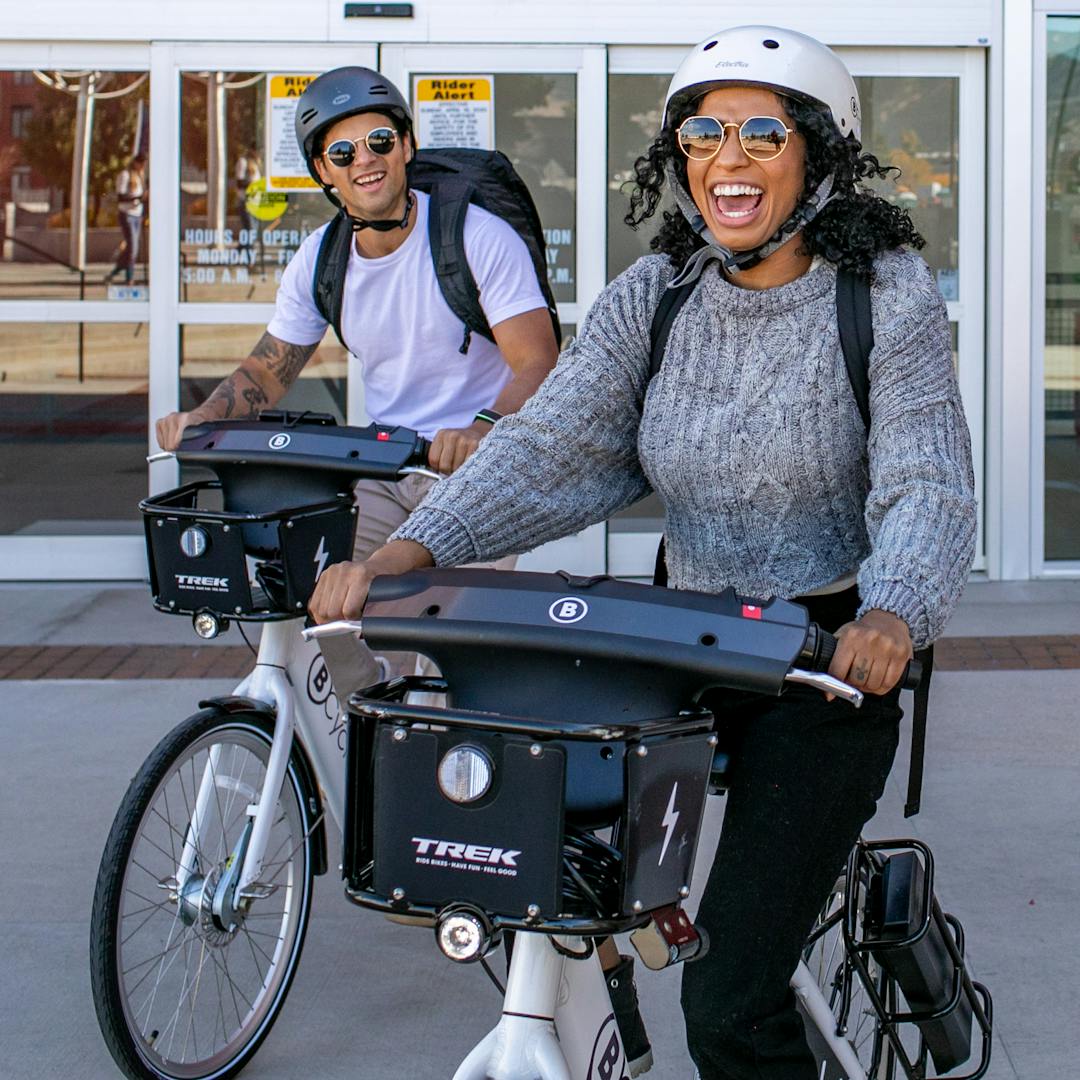 Two people on shared e-bikes 