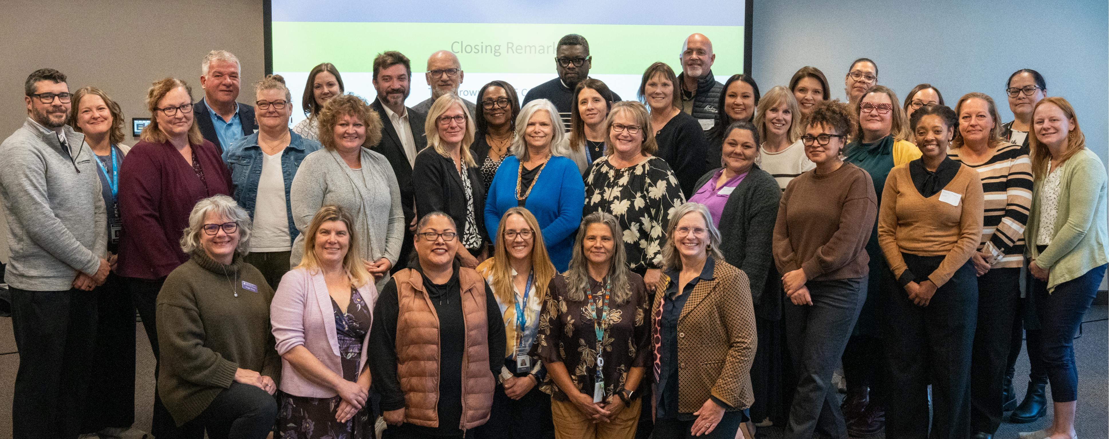 Family walking through the woods holding hand on a bright fall day. 