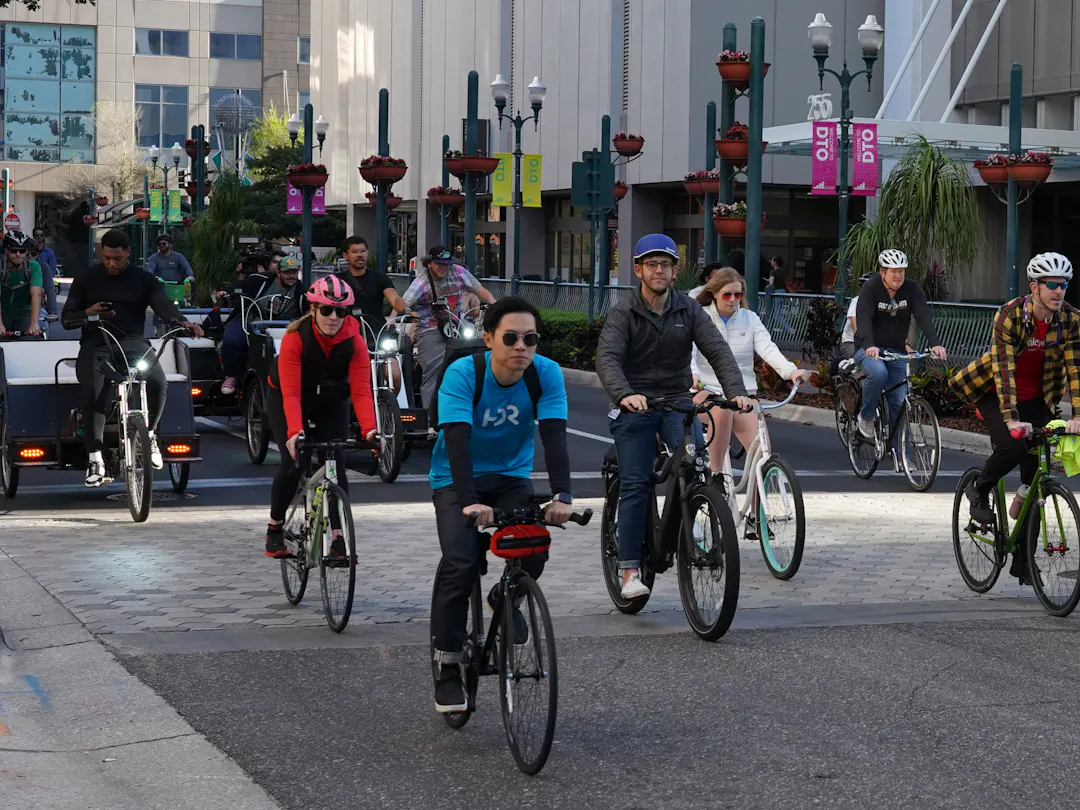 Bicyclists riding down street during the 2024 Orlando Bike to Work Day event. 