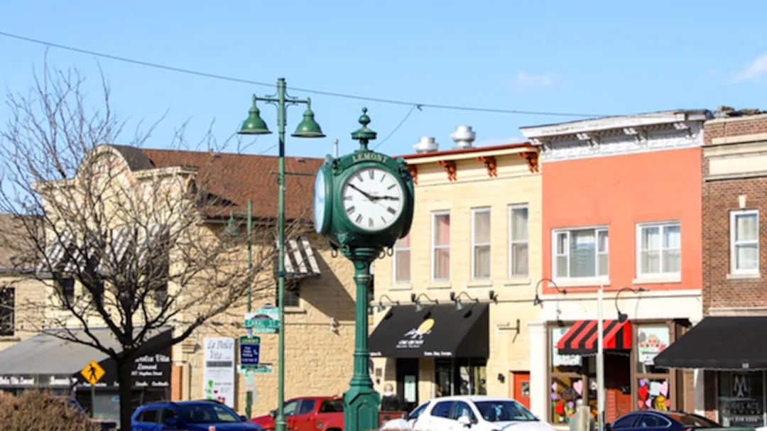 Clock stand in green in a neighborhood