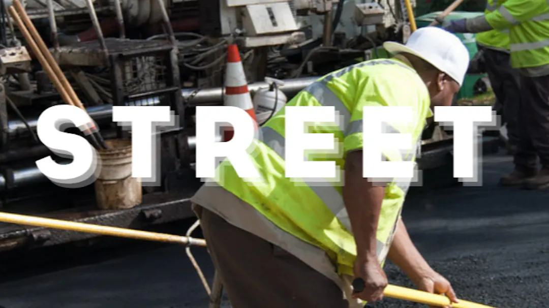 Road crews completing street paving as part of Houston Street improvement work.