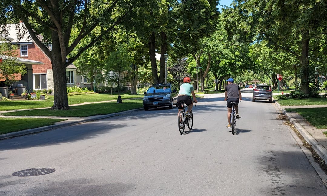 Two people riding bicycles in Oak Park