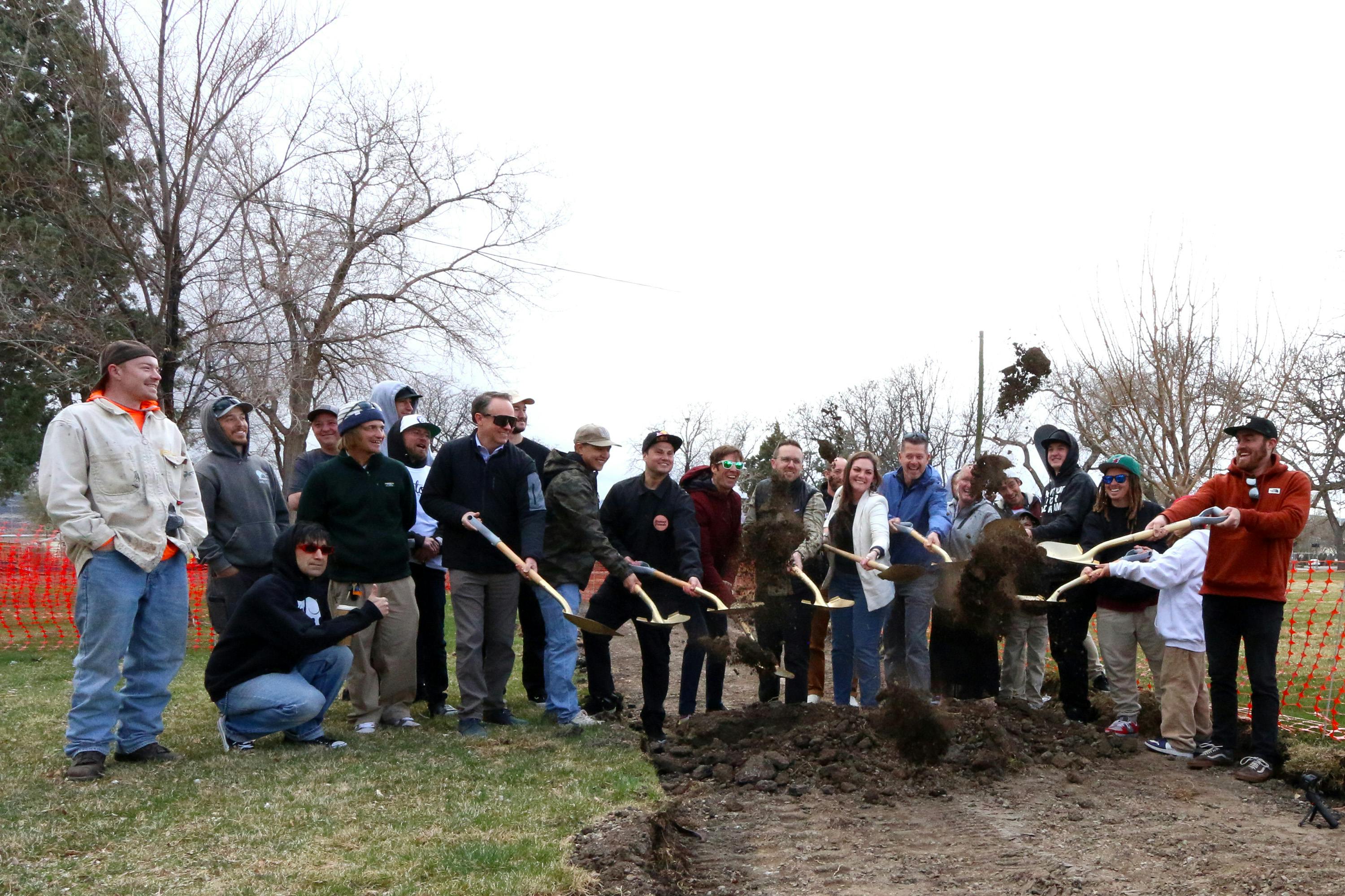 Emerson Groundbreaking with people grouped together shoveling the first hole for the skate park