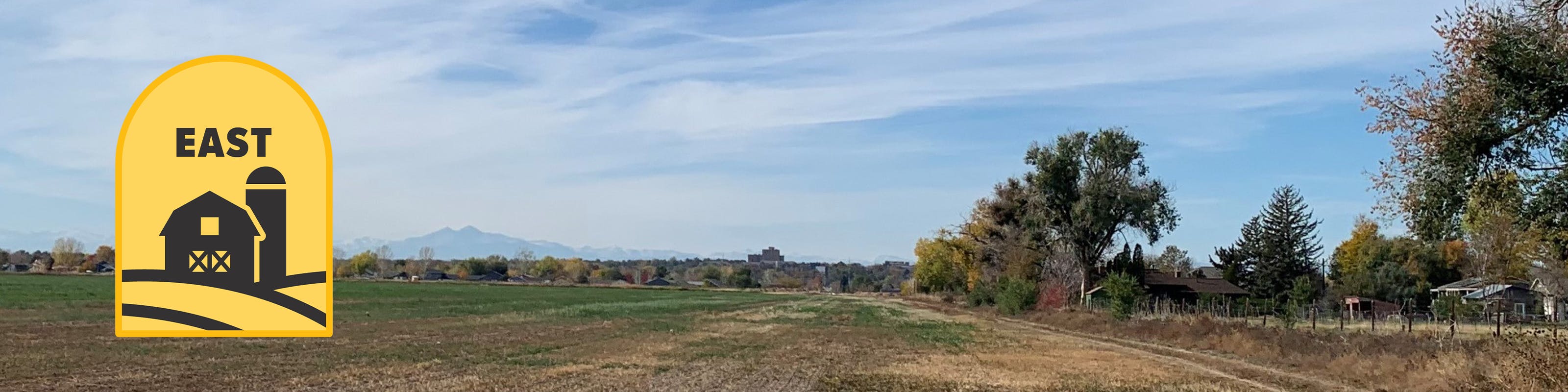 Looking west towards Greeley with agriculture land in the foreground and the city in the background at sunset.