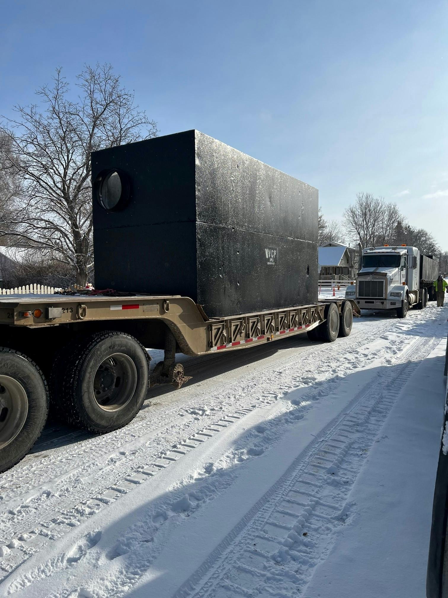 March 10, 2022 - The underground water quality structure was delivered by two trucks, combined, it weighs close to 47,000 pounds and is 17-ft x 7-ft.  The large size helps with storage of sediment removed by the device.