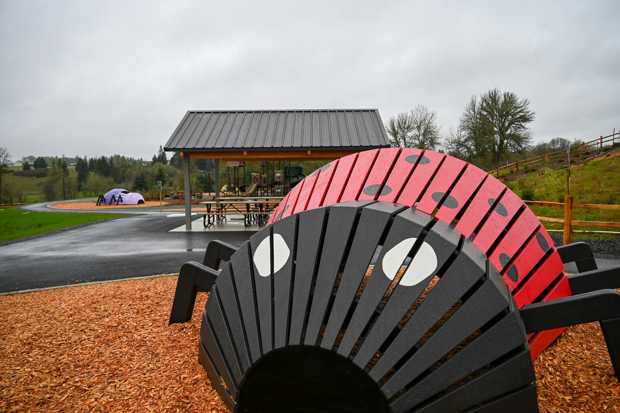 Unique bug play structures at Storybook Hollow Park.