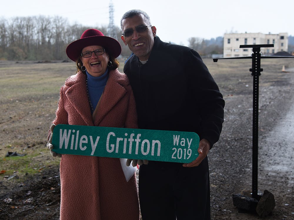 Mayor Lucy and Eric Richardson, president of Eugene Springfield NAACP, hold the Wiley Griffon Way sign, which honors one of Eugene's earliest documented African American residents. 