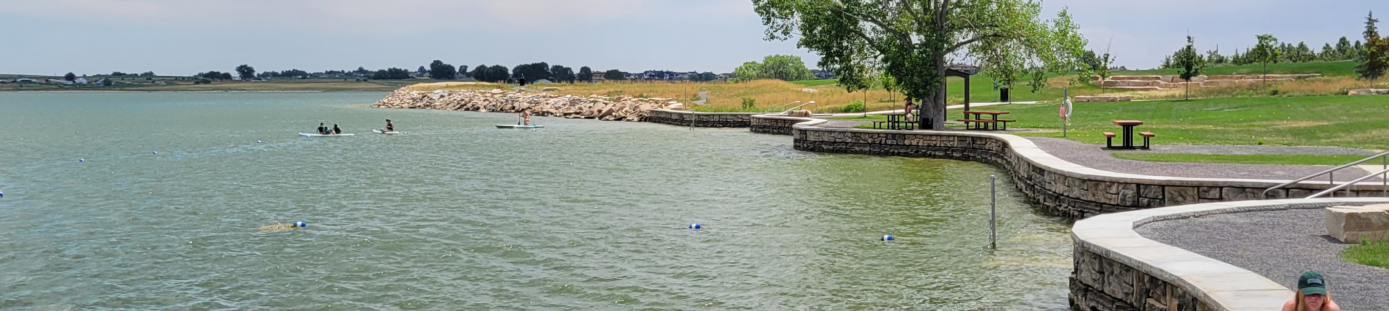 Timnath Reservoir and Shoreline, with paddleboarders in the water.