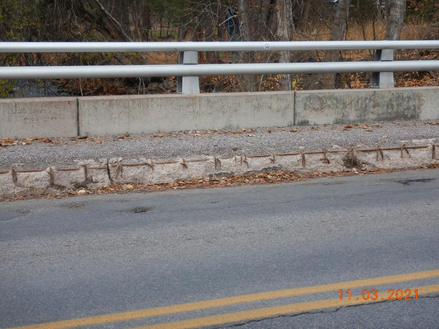 Exposed rebar along the northern sidewalk on the bridge