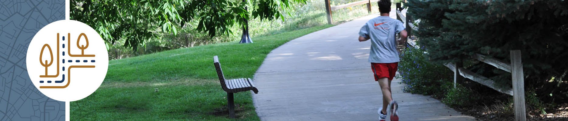 Person jogging on a park trail.