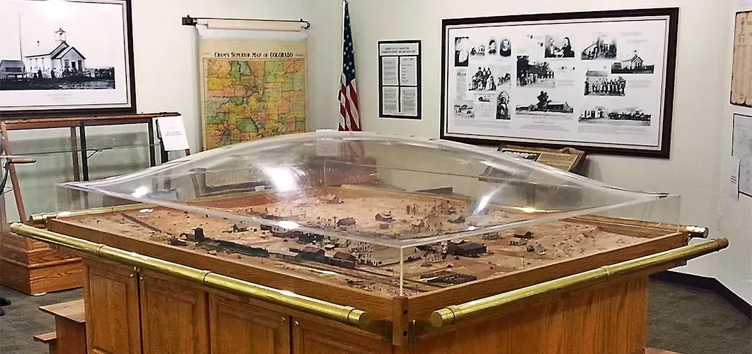 A photo of the Parker Heritage Center with a central diorama of historic Parker and walls of posters, maps and photos.