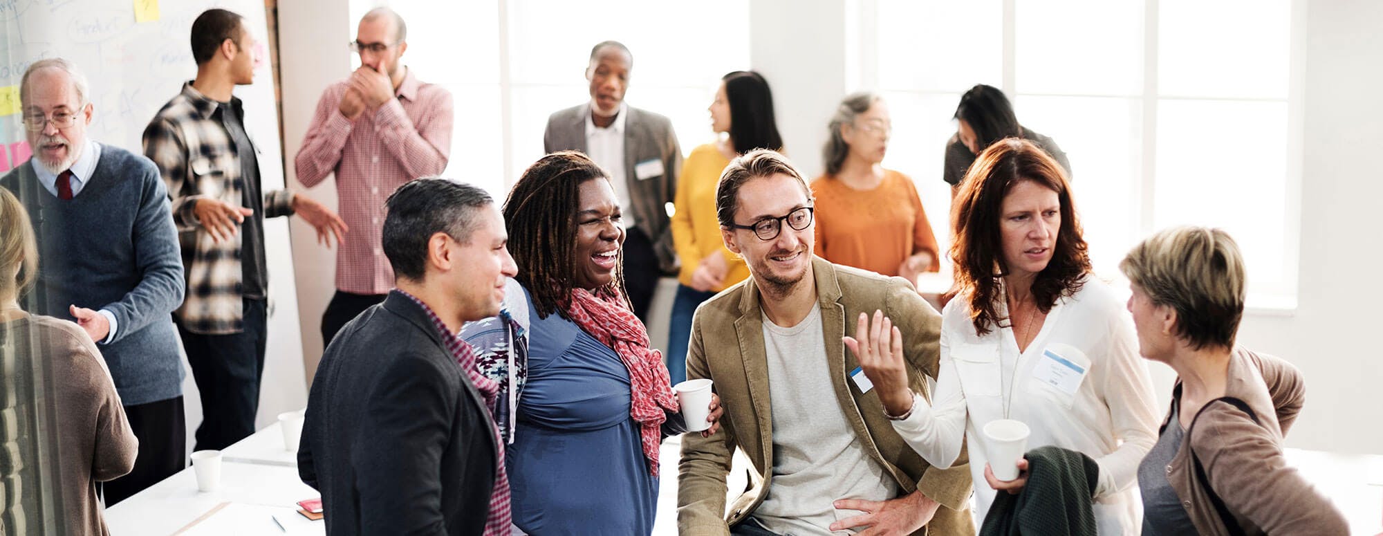 Diverse group of people talking to each other at a public meeting