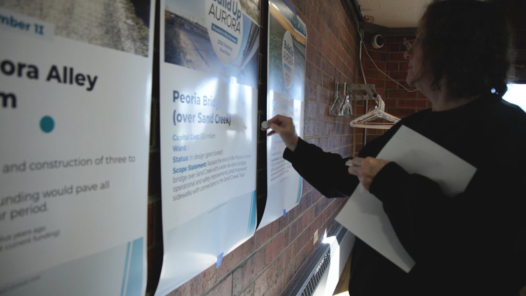 A graphic with photos of a recreation center, library and road with icons of infrastructure and words supporting the copy