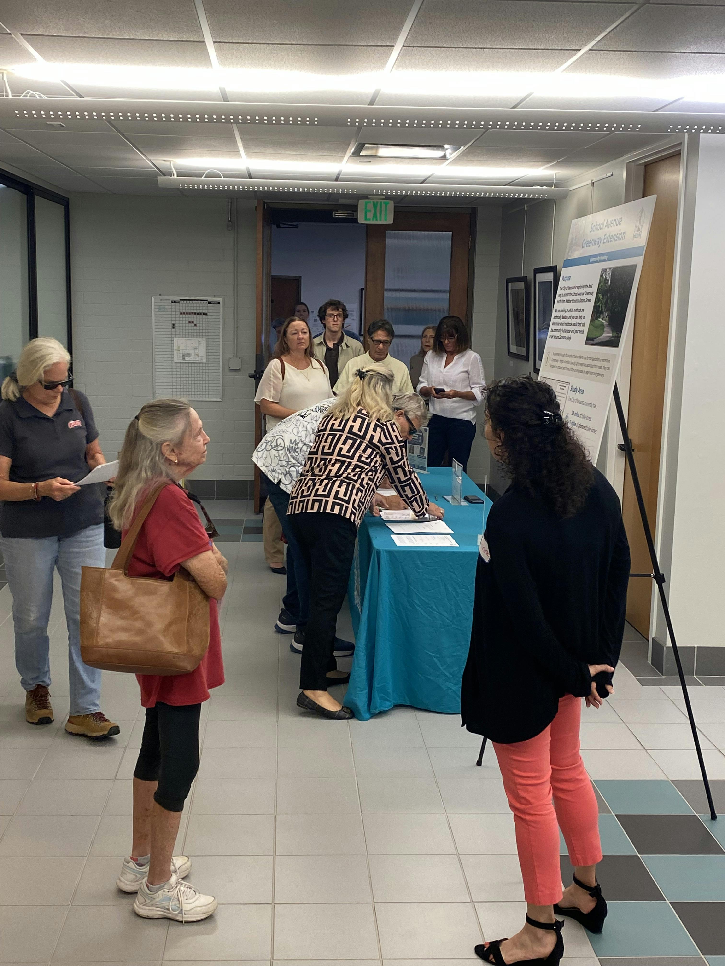 Project manager introducing project to people who enter