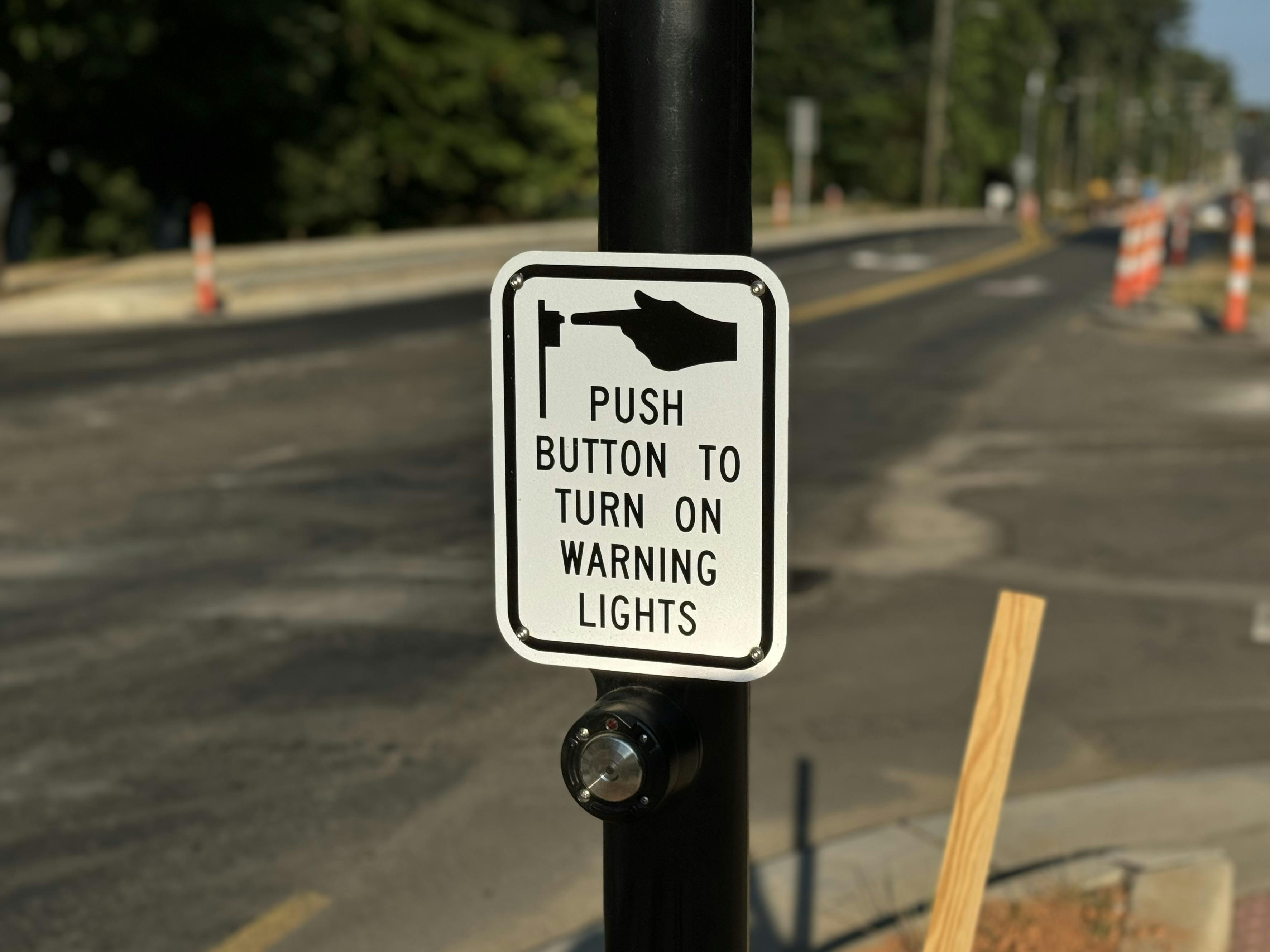 Sign showing how to operate crossing signal