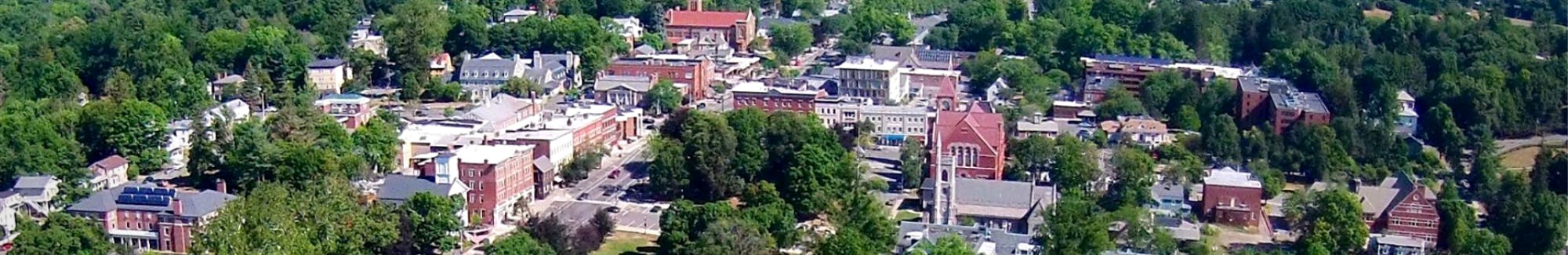 aerial drone image of Amherst Town Center with UMass in background