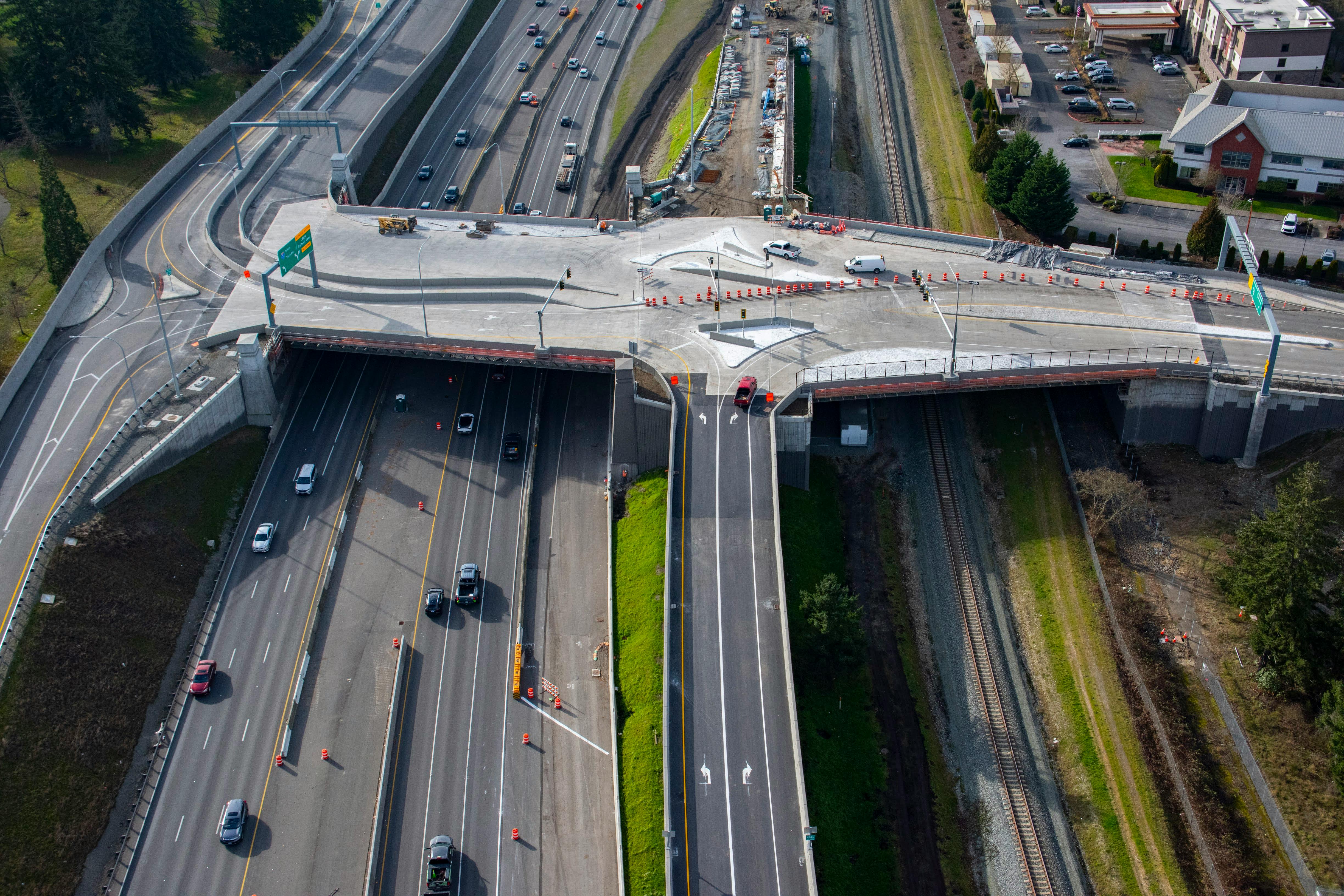 An aerial view of the new diverging diamond interchange taking shape in DuPont with I-5 traffic flowing below it.
