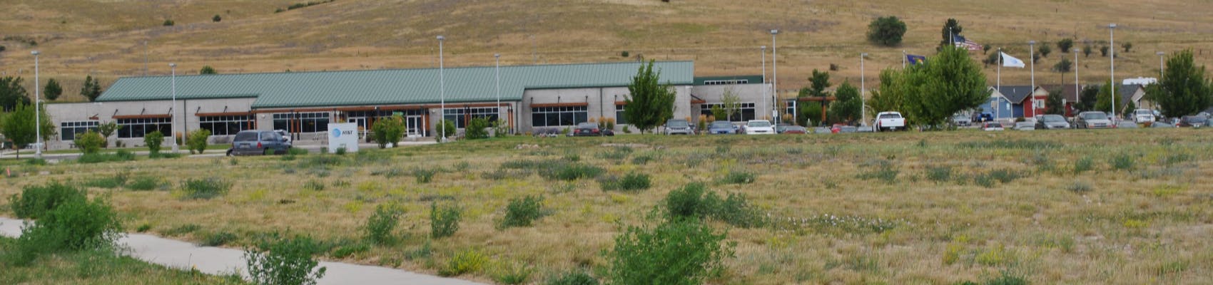 View of Missoula Development Park, including AT&T and parking lot and grassy area.