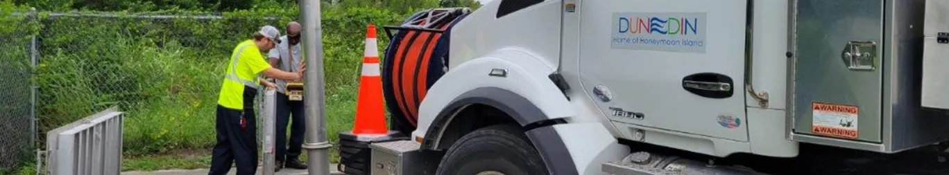 Photo of two men conducting Stormwater Rate Study with Dunedin truck in frame