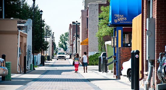 People walk down a downtown Alleyscape August 9, 2013