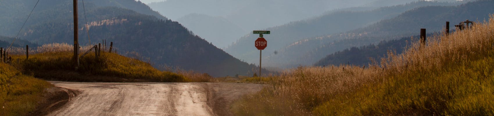 View of Wye from Deschamps Lane. Shows dirt road and mountains in distance on summer evening