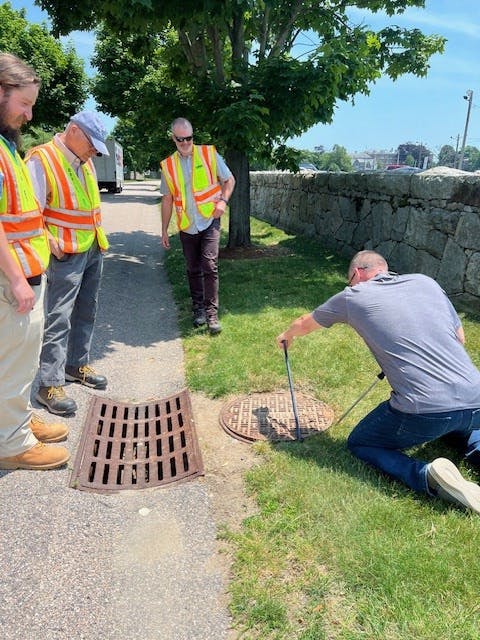 Paul F lifting mh cover on old model.jpg