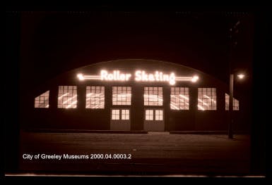 The Warnoco building (date unknown) with lights on at night.