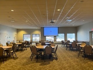 A banquet hall filled with table and chairs.