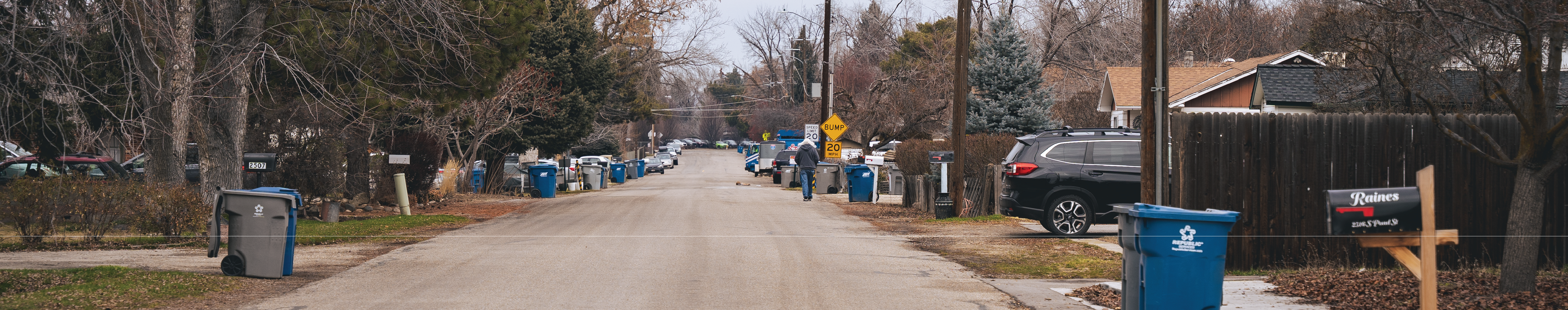 Street without sidewalks and someone walking 