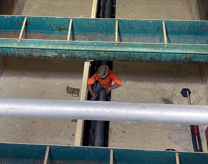 A construction worker prepares Filter 5 for the installation of the underdrain.