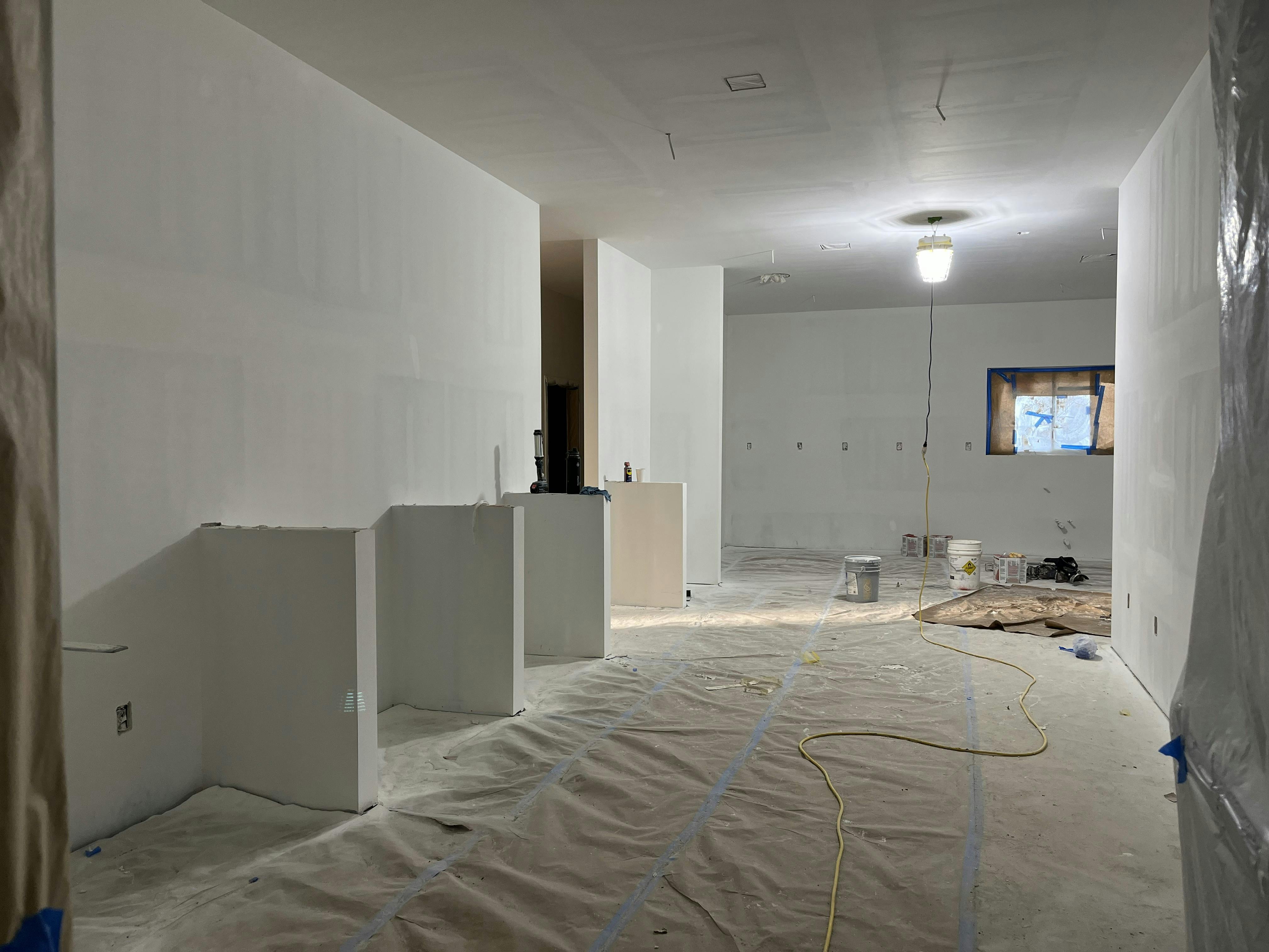 Control Building drywall has been mudded and the primer coating of paint applied.