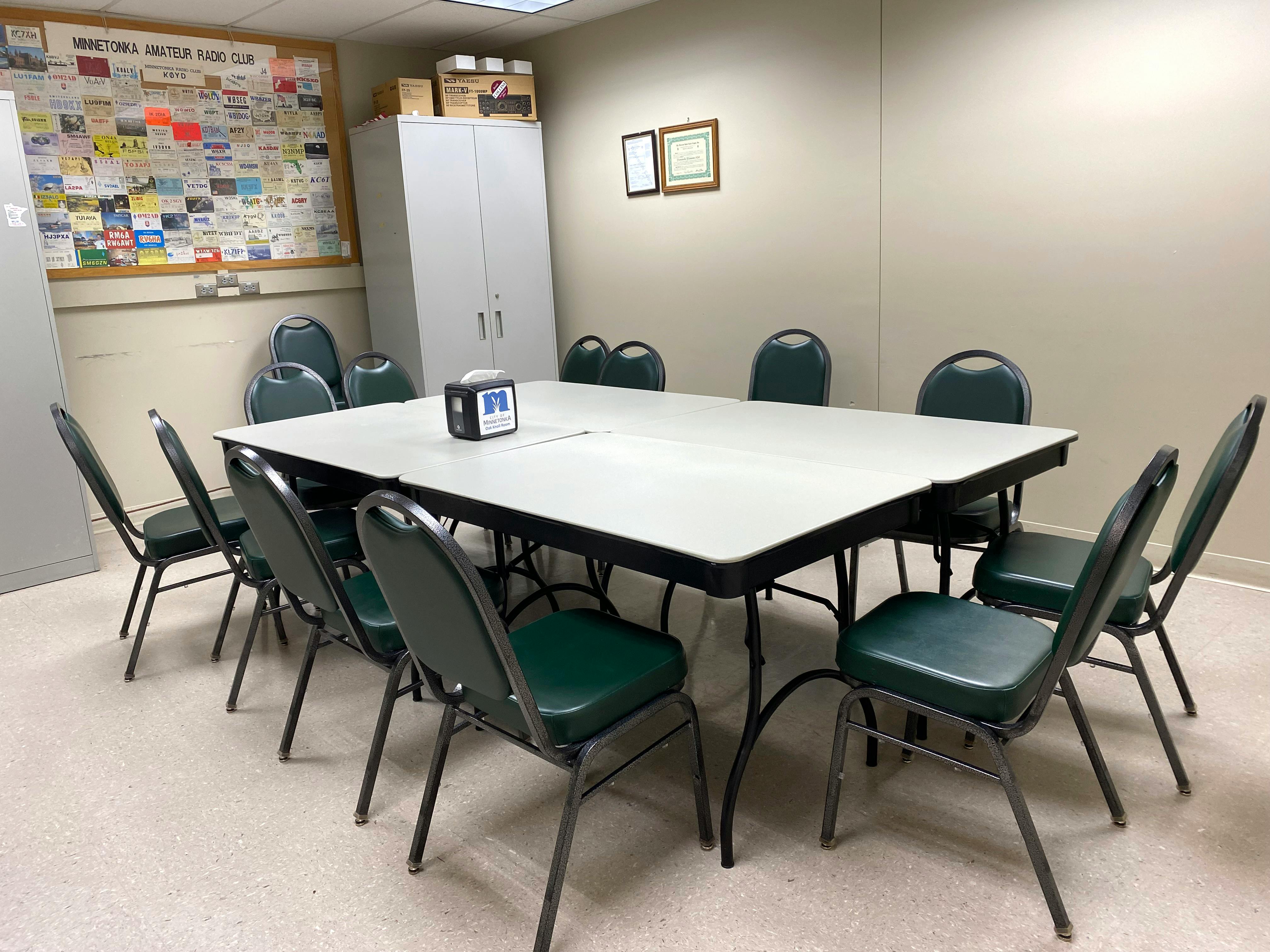 A meeting room with a table and chairs.