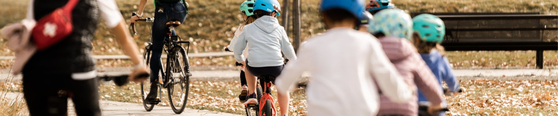 Kids ride their bikes on a fall day in Story Mill Community Park