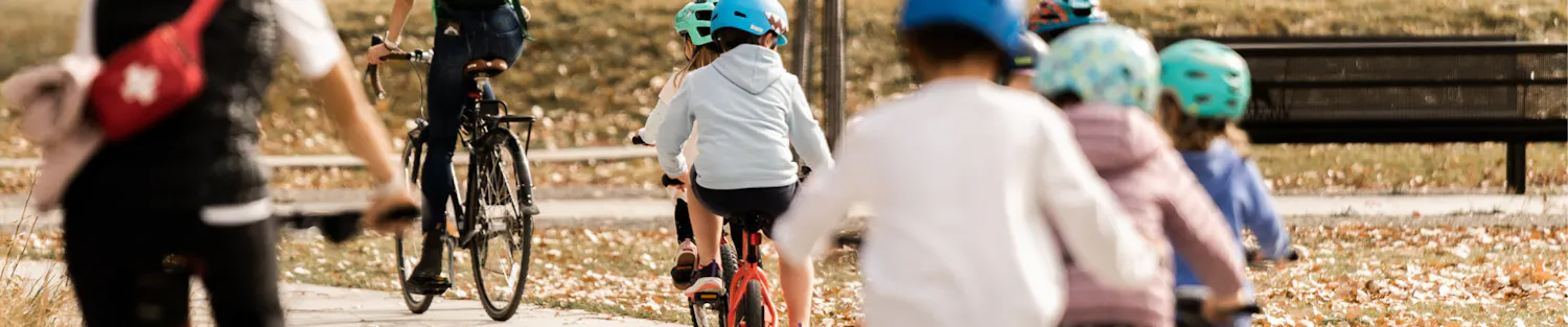 Kids ride their bikes on a fall day in Story Mill Community Park