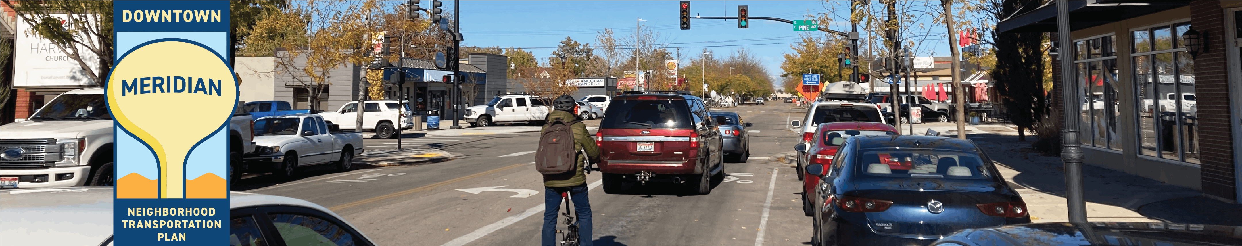 Downtown Meridian with cars, bicyclist and project logo