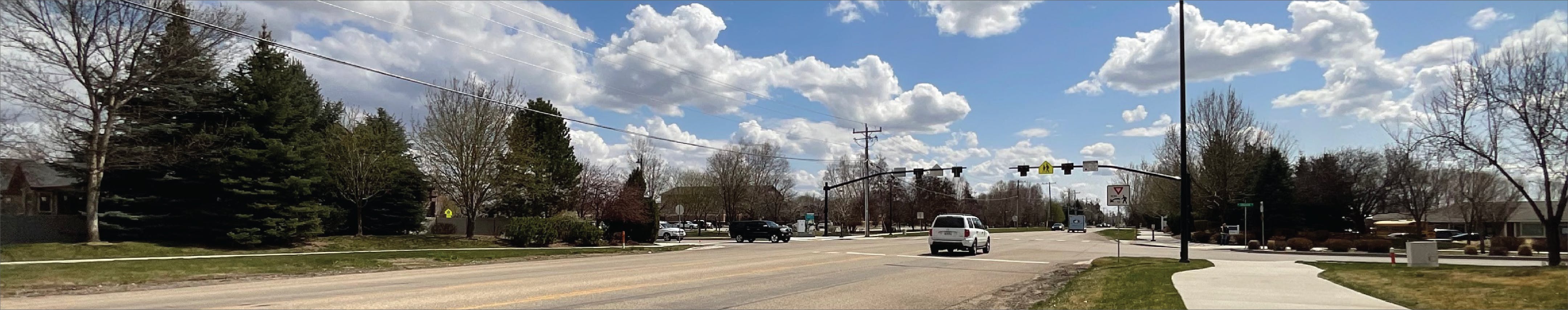 Photo of Linder Road with traffic and pedestrian crossing in the background.