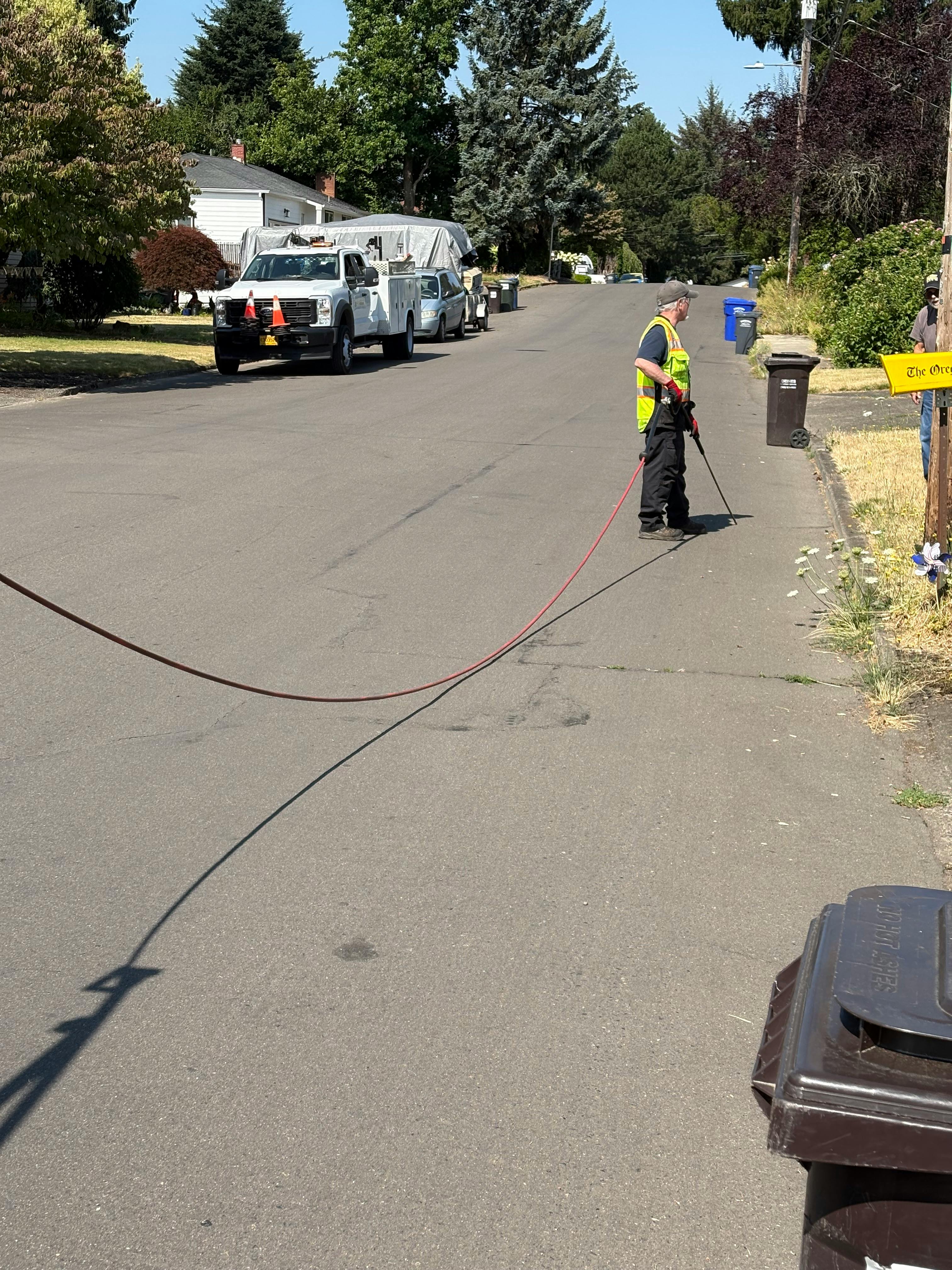 Public Works Staff Filling Cracks in Road with Sealant