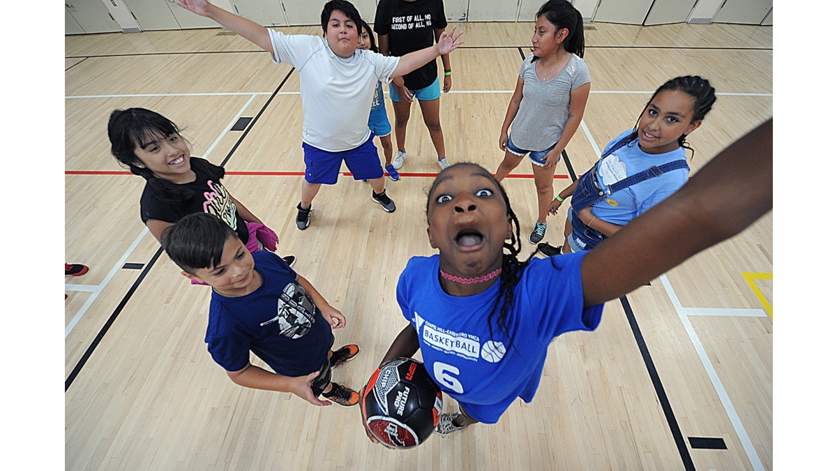 Photo of kids at summer camp playing basketball