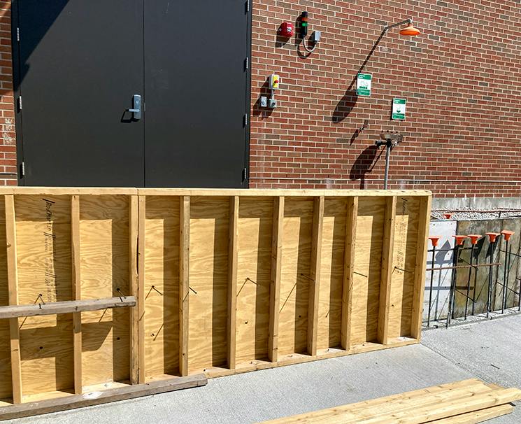 Frames are in place where crews will pour concrete for a retaining wall in front of the Chemical Building.