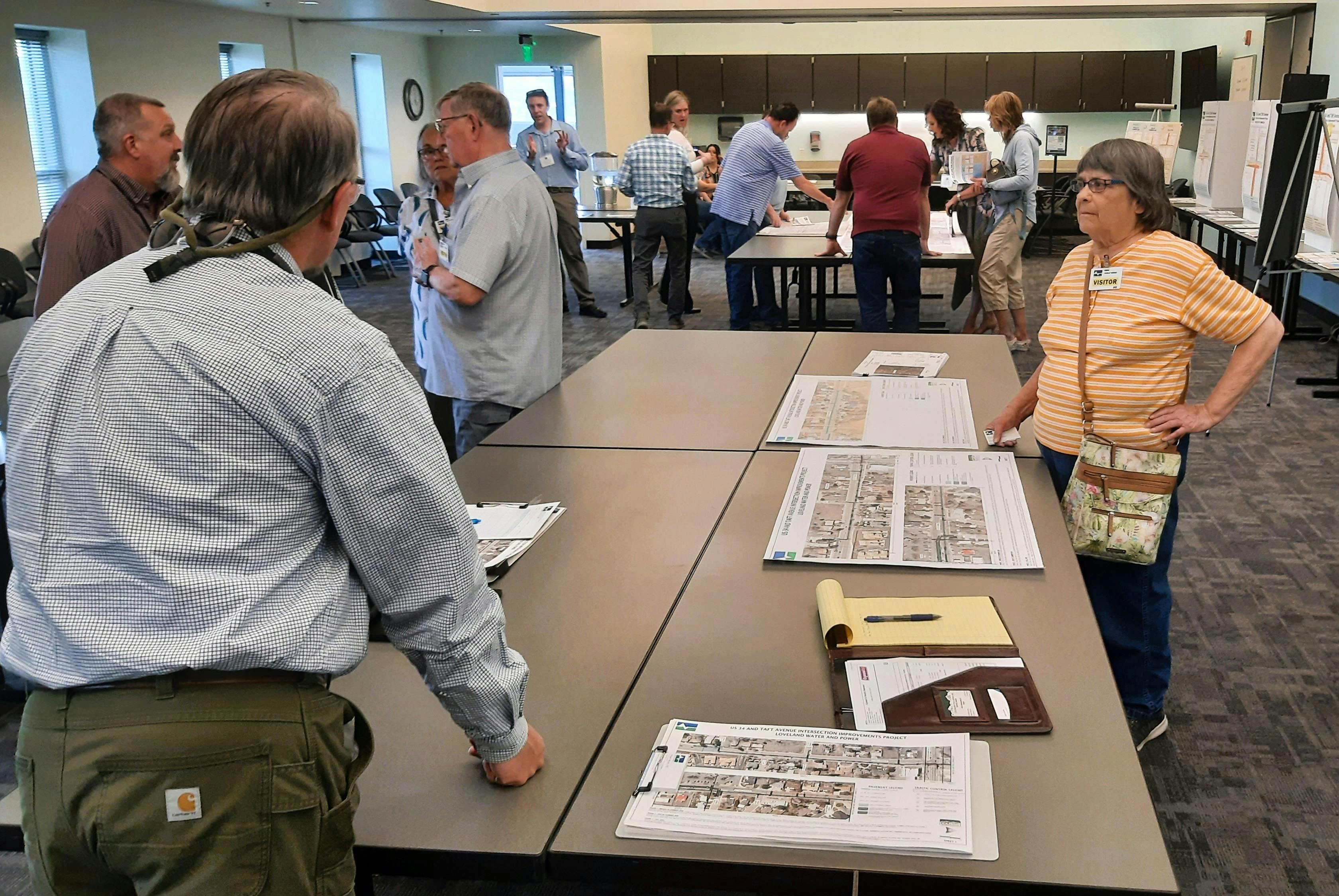 Project engineers discuss utility and road improvements with residents at the April 24 open house. 