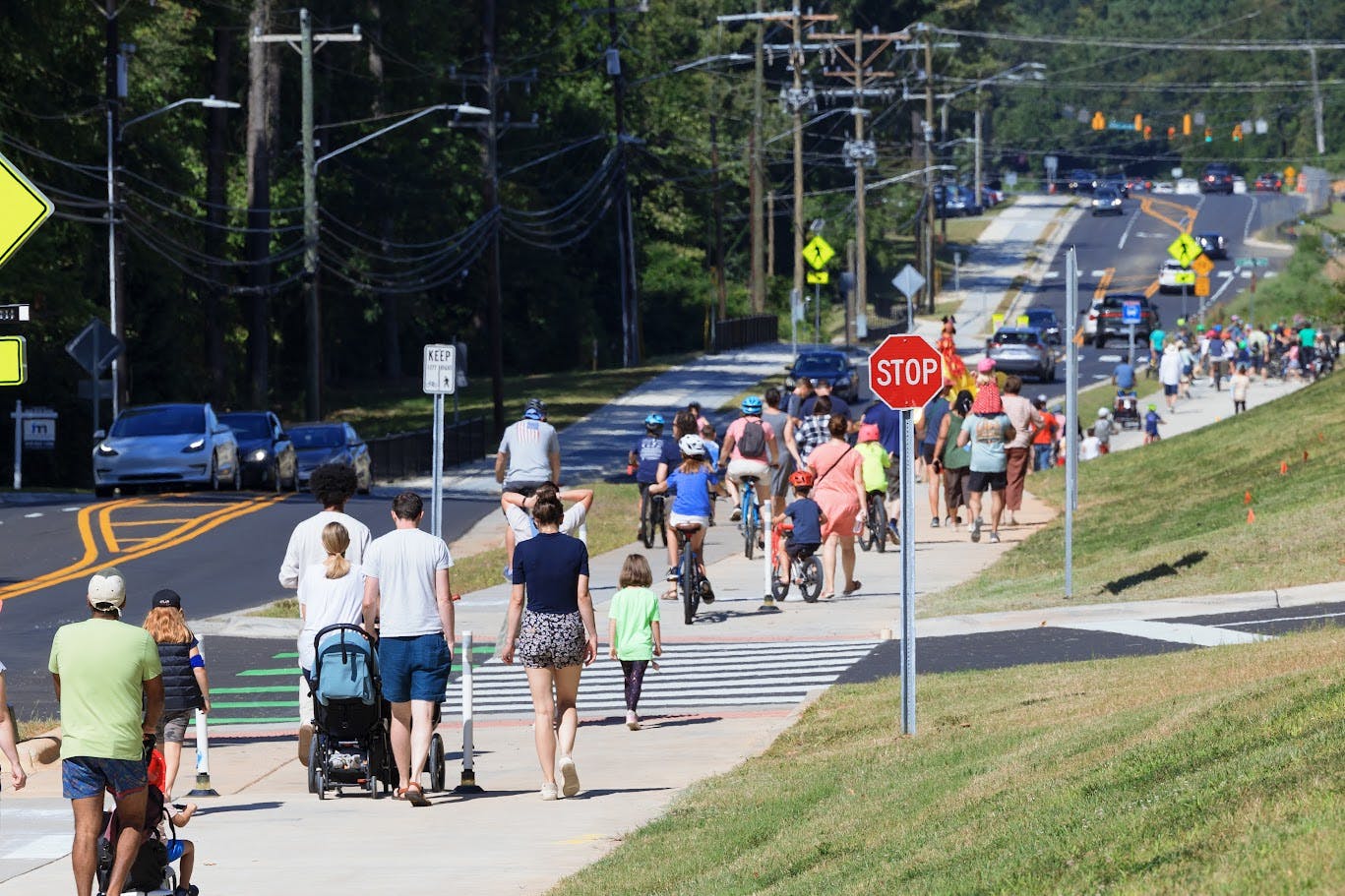 People walking along the new pedestrian path along Estes Drive.