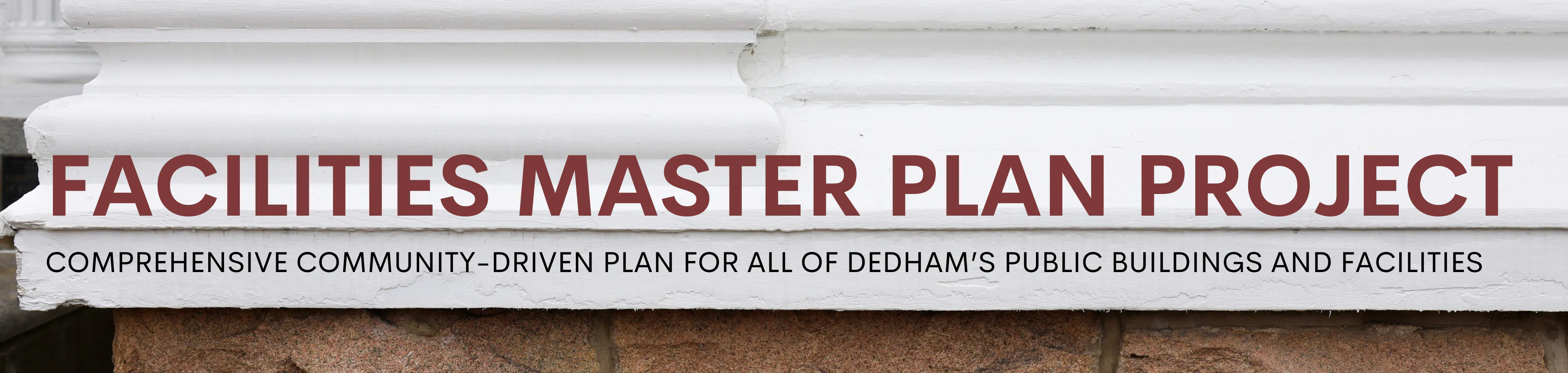 Close up of white wood trim, gray shingle siding, and stone base with text that reads Facilities Master Plan Project