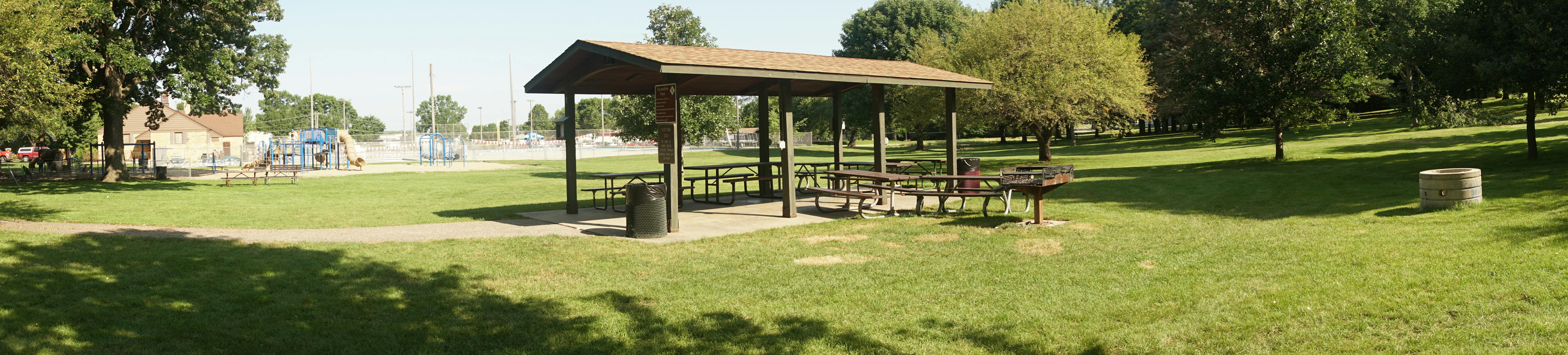 Tourtellotte Park shelter with pool and play system in the background.