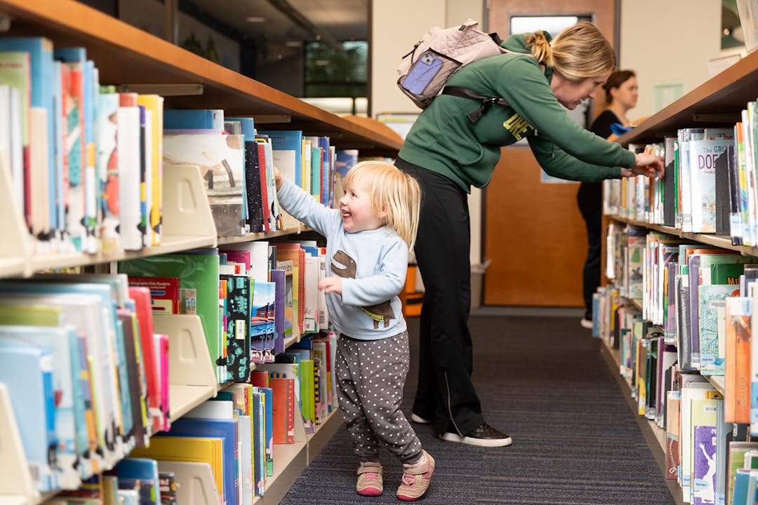 Child picking out a book
